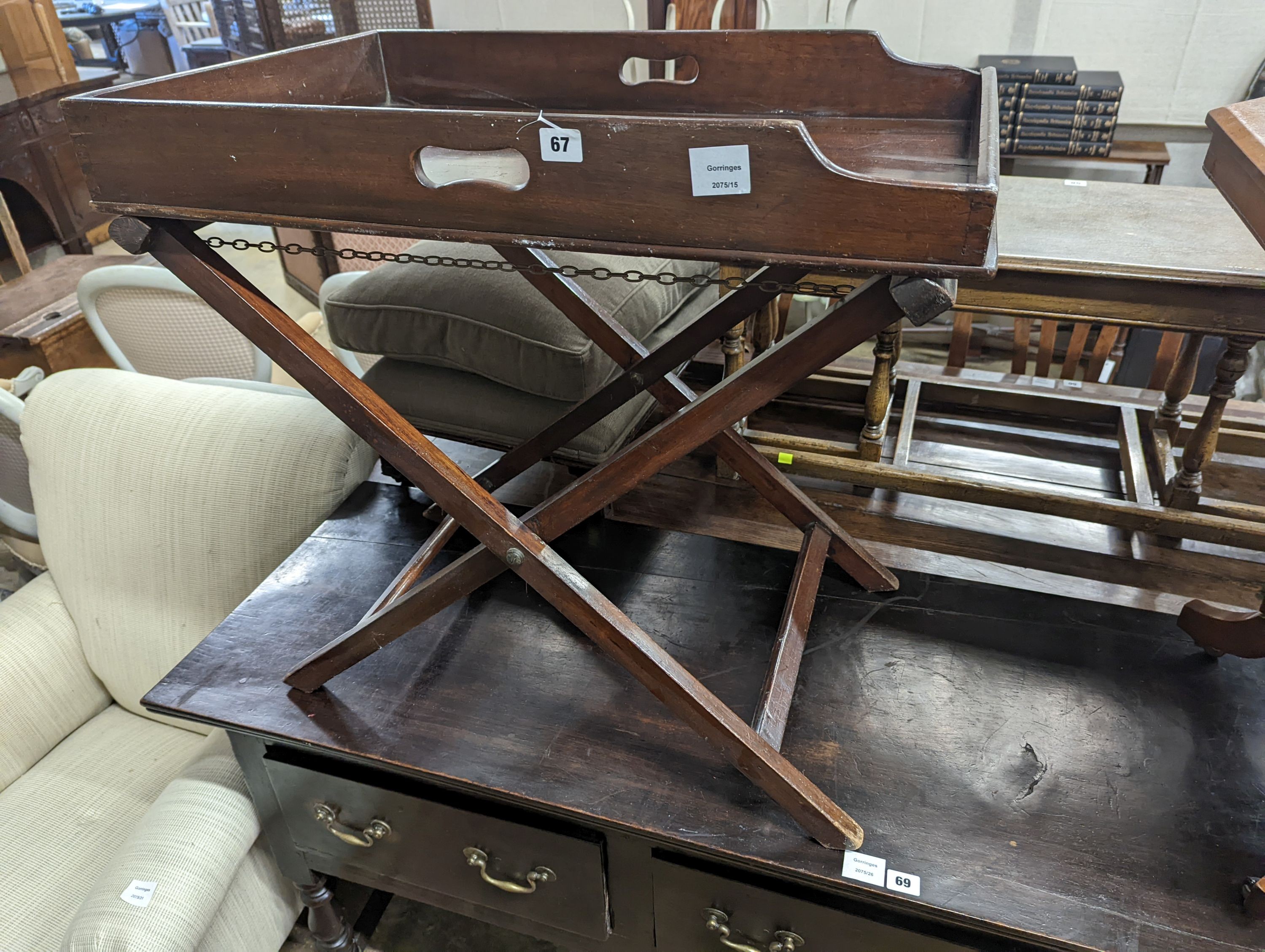 A 19th century rectangular mahogany butler's tray on folding stand, width 24cm, depth 49cm, height 71cm